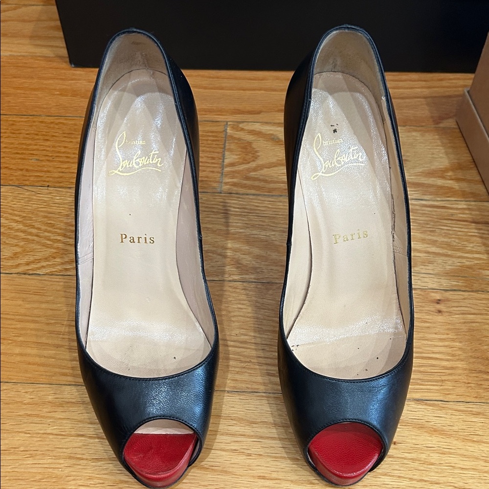 Christian Louboutin Black Peep Toe Heels with Red Soles.